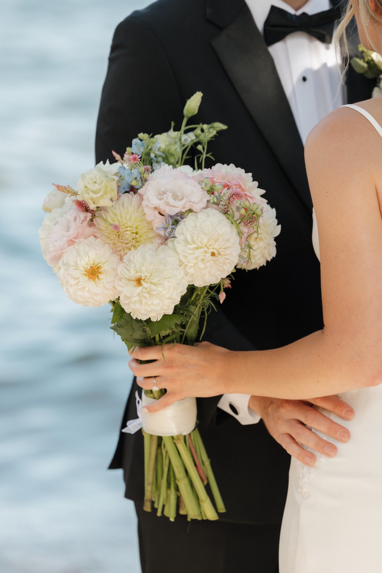 Bridal bouquet of white dahlias and soft pastel blooms